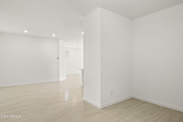 unfurnished room featuring baseboards, light wood-type flooring, and recessed lighting