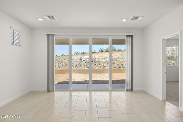 unfurnished room featuring light tile patterned floors, baseboards, recessed lighting, and visible vents