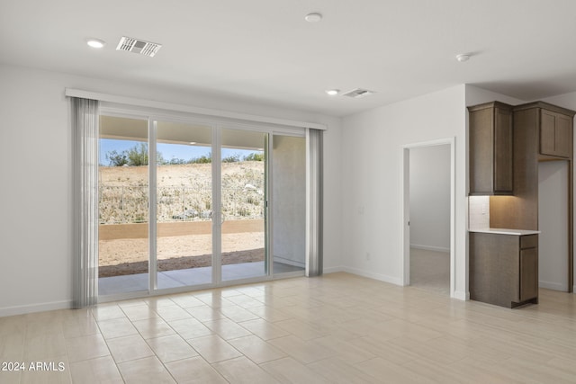 unfurnished living room featuring baseboards, recessed lighting, and visible vents