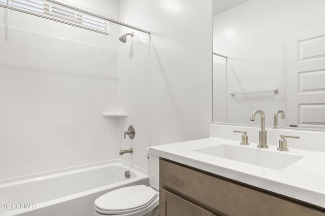 bathroom featuring washtub / shower combination, vanity, and toilet
