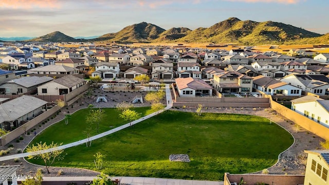 aerial view at dusk with a mountain view and a residential view