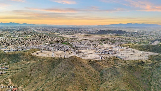 aerial view at dusk featuring a mountain view