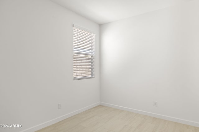 unfurnished room with baseboards