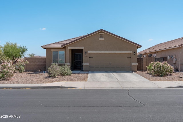 24349 W Gregory Rd, Buckeye, AZ 85326 - ranch-style home with concrete driveway, a tiled roof, an attached garage, fence, and stucco siding