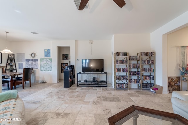 24349 W Gregory Rd, Buckeye, AZ 85326 - living room with stone finish floor, visible vents, and ceiling fan