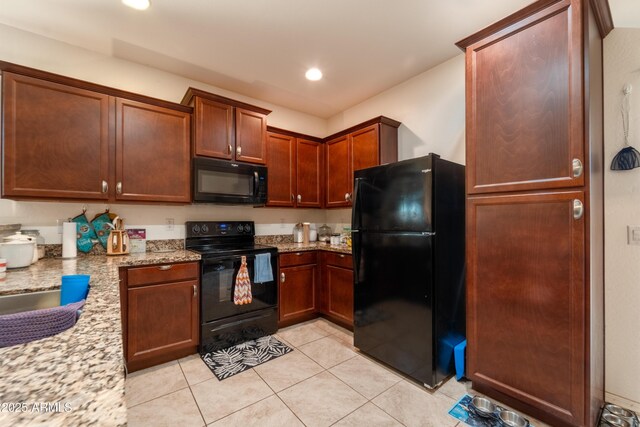 24349 W Gregory Rd, Buckeye, AZ 85326 - kitchen with black appliances, recessed lighting, light stone counters, and light tile patterned floors