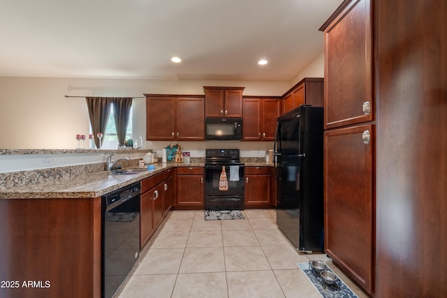 24349 W Gregory Rd, Buckeye, AZ 85326 - kitchen featuring recessed lighting, light stone counters, light tile patterned floors, a sink, and black appliances