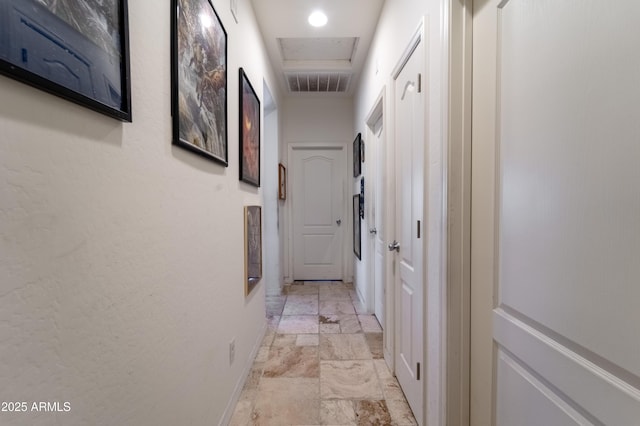 24349 W Gregory Rd, Buckeye, AZ 85326 - hallway featuring recessed lighting, stone tile flooring, visible vents, and baseboards