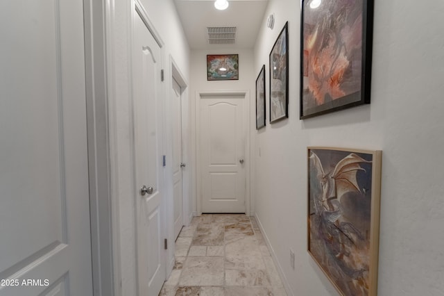 24349 W Gregory Rd, Buckeye, AZ 85326 - hall with stone finish floor, visible vents, and baseboards