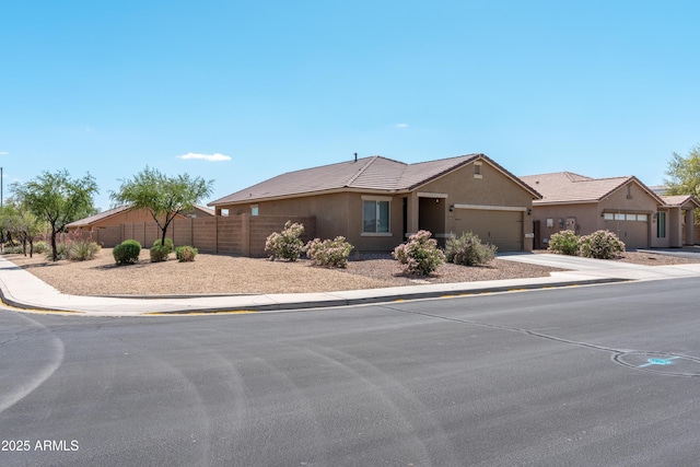 24349 W Gregory Rd, Buckeye, AZ 85326 - ranch-style house with fence, stucco siding, a tile roof, driveway, and a garage