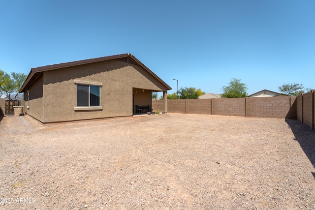 24349 W Gregory Rd, Buckeye, AZ 85326 - back of property featuring a tile roof, a fenced backyard, and stucco siding