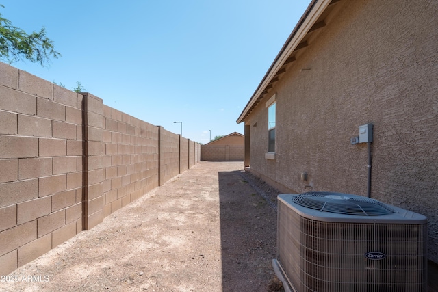 24349 W Gregory Rd, Buckeye, AZ 85326 - view of home's exterior featuring central AC and a fenced backyard