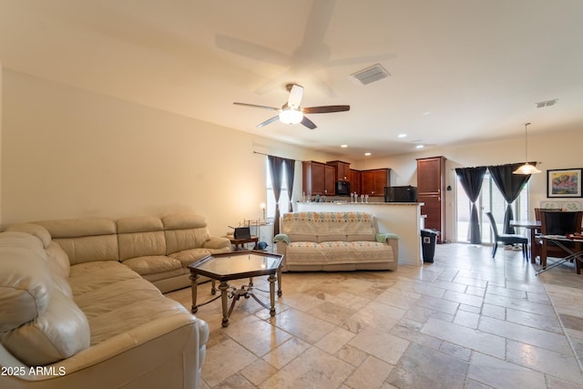 24349 W Gregory Rd, Buckeye, AZ 85326 - living room with visible vents, stone tile flooring, recessed lighting, and ceiling fan