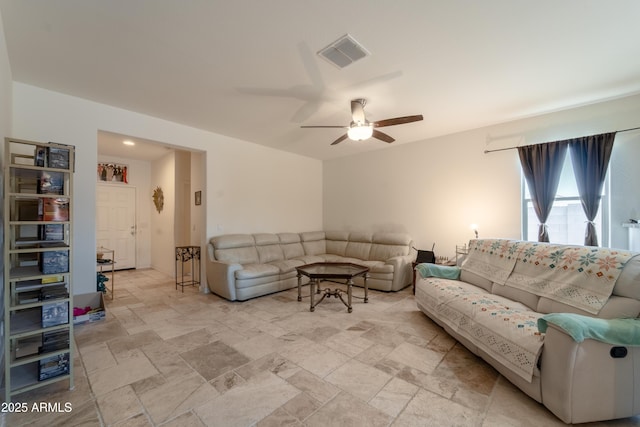 24349 W Gregory Rd, Buckeye, AZ 85326 - living room featuring a ceiling fan, stone tile flooring, and visible vents