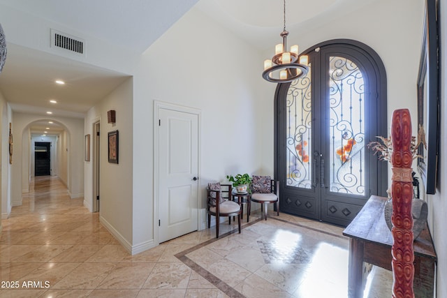 foyer entrance featuring a notable chandelier