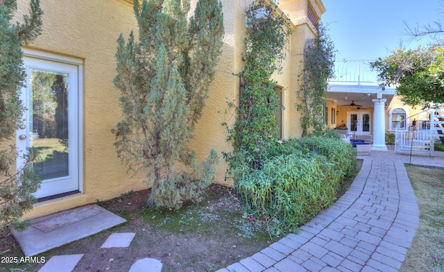 exterior space with ceiling fan and a balcony