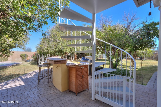 view of patio / terrace featuring grilling area, exterior bar, and area for grilling