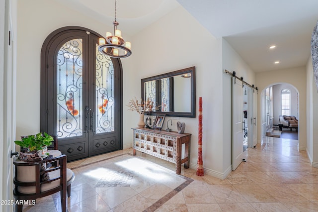 entryway with a barn door and french doors