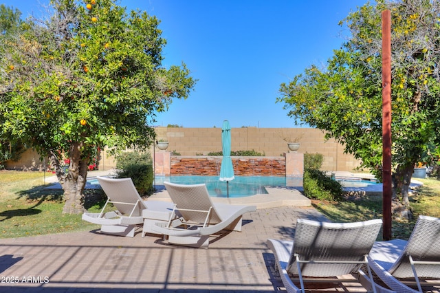 view of patio with a fenced in pool