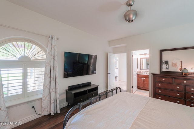 bedroom featuring connected bathroom and dark hardwood / wood-style floors