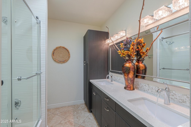 bathroom featuring an enclosed shower, vanity, and tile patterned flooring