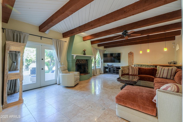 tiled living room featuring beam ceiling, french doors, plenty of natural light, and a stone fireplace