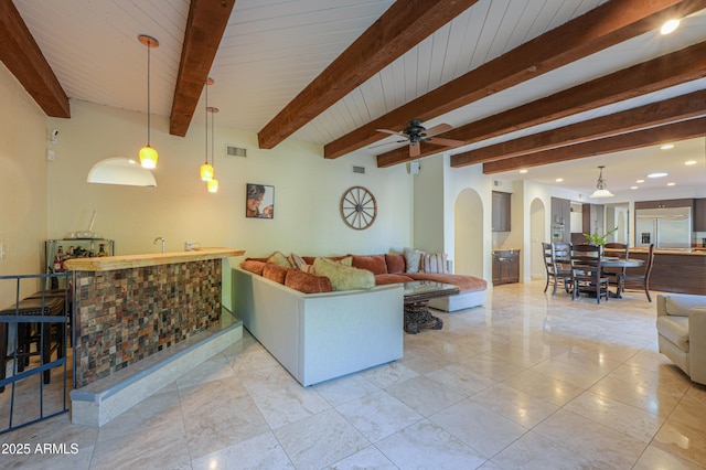 living room with bar, wooden ceiling, beam ceiling, and ceiling fan