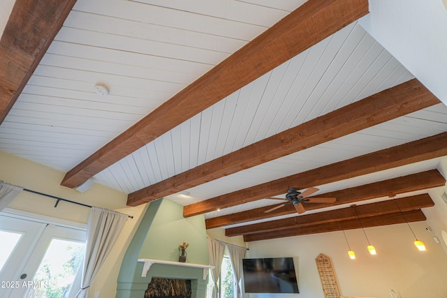 room details featuring ceiling fan, beam ceiling, and wood ceiling