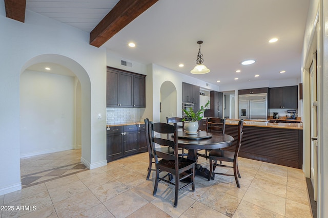 dining room with beam ceiling and light tile patterned flooring