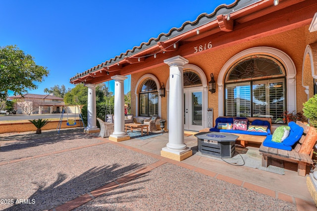 view of patio / terrace featuring an outdoor living space with a fire pit