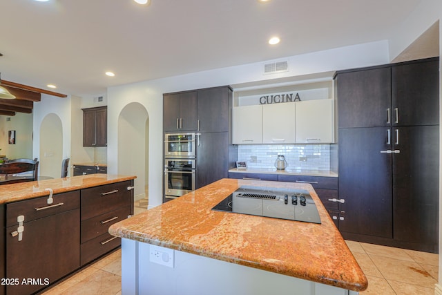 kitchen with a center island, decorative backsplash, white cabinets, double oven, and black electric cooktop