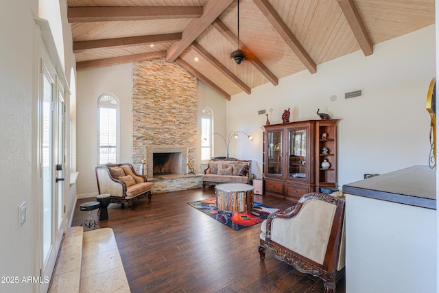 living room featuring a fireplace, beamed ceiling, hardwood / wood-style flooring, wood ceiling, and high vaulted ceiling