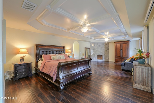 bedroom with ceiling fan, dark wood-type flooring, a fireplace, and coffered ceiling