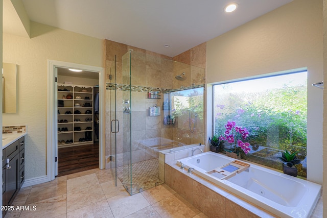 bathroom featuring vanity, independent shower and bath, and tile patterned flooring