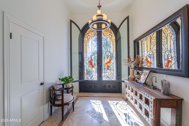 entrance foyer featuring light tile patterned floors and french doors