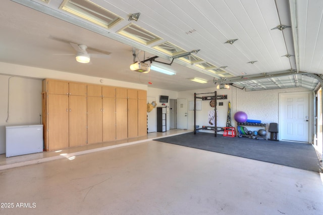 garage featuring fridge and a garage door opener