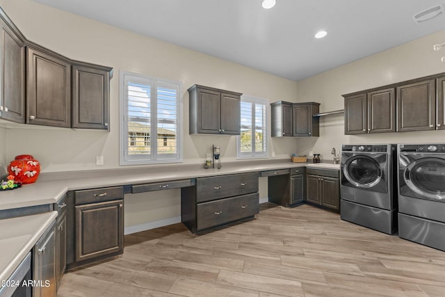 washroom featuring separate washer and dryer, recessed lighting, cabinet space, a sink, and light wood-type flooring