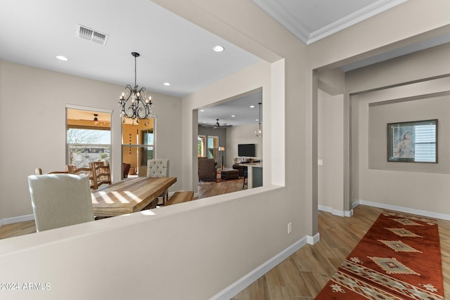 corridor featuring a notable chandelier and light hardwood / wood-style floors