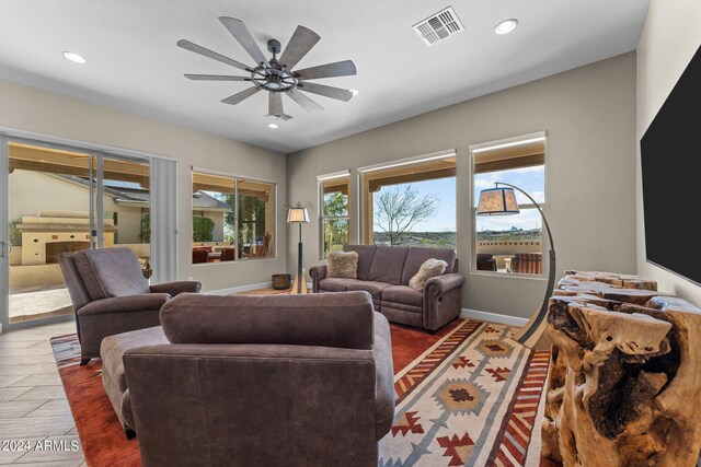 living room with ceiling fan and hardwood / wood-style floors