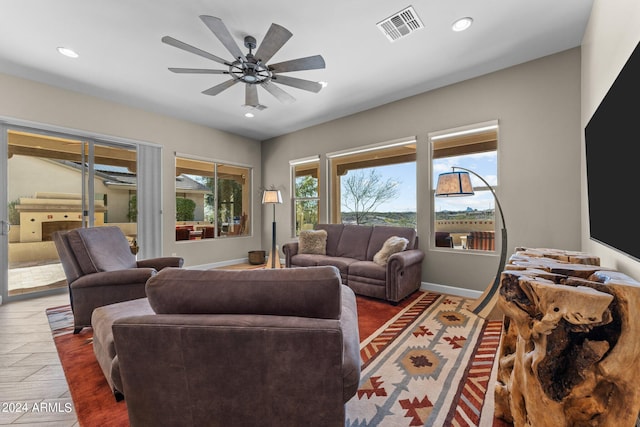 living area featuring visible vents, baseboards, recessed lighting, wood finished floors, and a ceiling fan