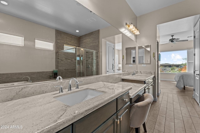 bathroom with ceiling fan, double vanity, plus walk in shower, and tile patterned floors