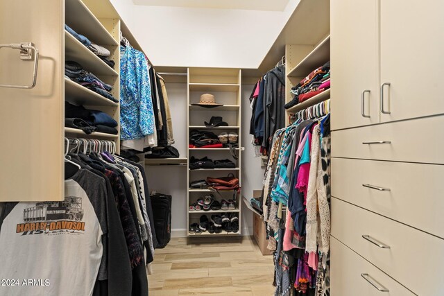 spacious closet with light hardwood / wood-style floors