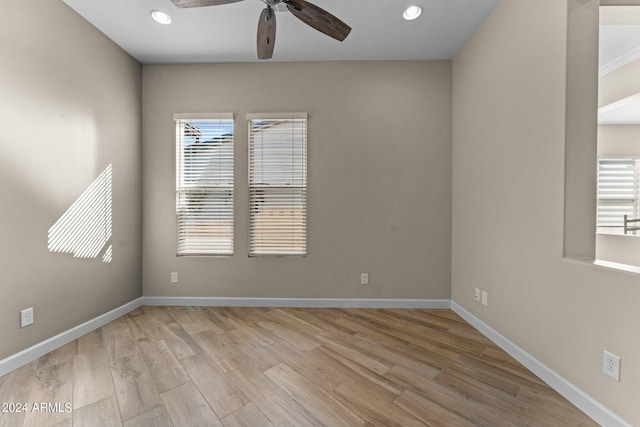 unfurnished room featuring recessed lighting, a healthy amount of sunlight, baseboards, and light wood finished floors