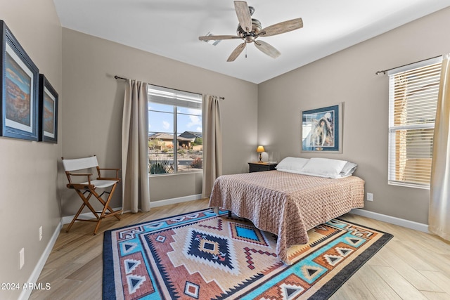 bedroom with ceiling fan and light hardwood / wood-style flooring