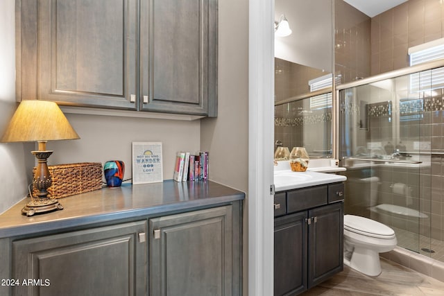 bathroom with a shower with door, toilet, vanity, and hardwood / wood-style flooring