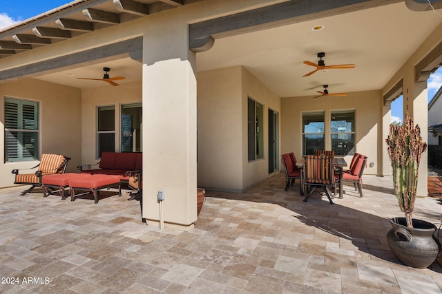 view of patio with outdoor dining area, outdoor lounge area, and a ceiling fan