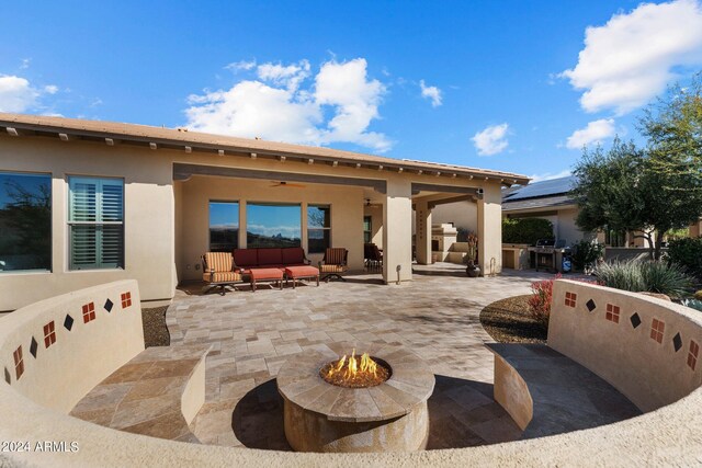 view of patio / terrace with an outdoor living space with a fire pit