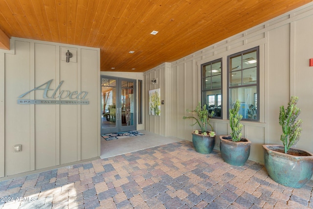 property entrance featuring french doors and board and batten siding