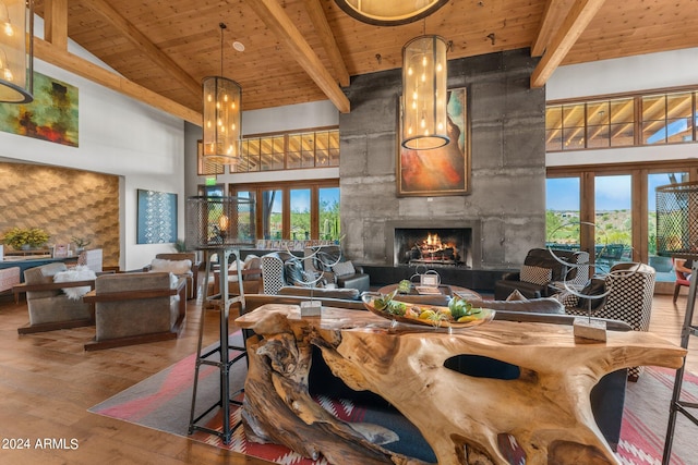 living room featuring hardwood / wood-style floors, high vaulted ceiling, beam ceiling, wooden ceiling, and a high end fireplace