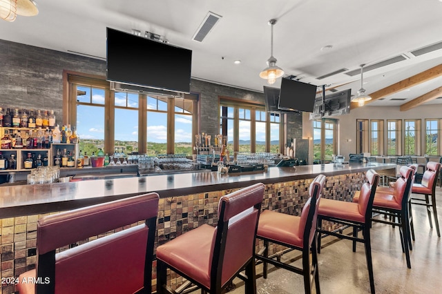 bar featuring beamed ceiling, ceiling fan, and decorative light fixtures